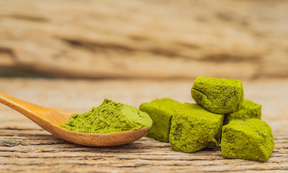 Matcha powder on a wooden spoon